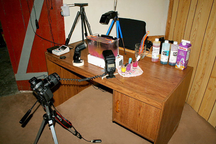 water drop photography - Setup 4. The setup I use for my liquid flow images and also the ones where the mushroom type drop is on top of the surface, with the delayed flash on the flow underneath. You can see I need both hands so I use the shutter button as a foot pedal.