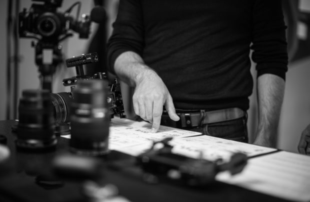 man discussing storyboard for product photograph