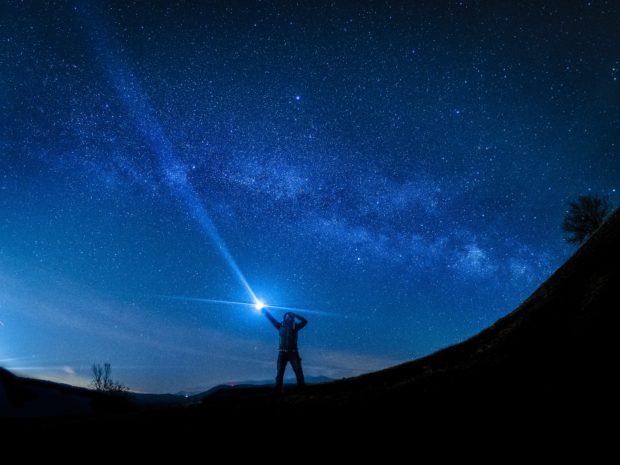 Man using flash for night time photography 