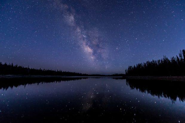 Lake with stars reflected at night 