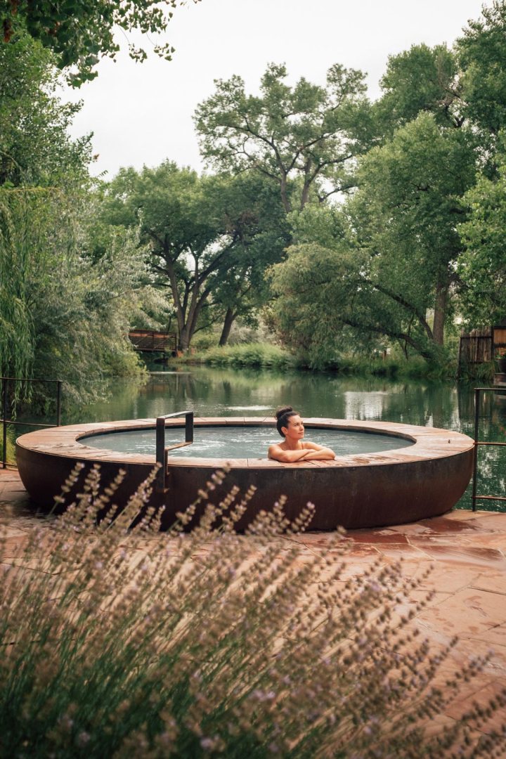 Woman relaxing in swimming pool in spa resort