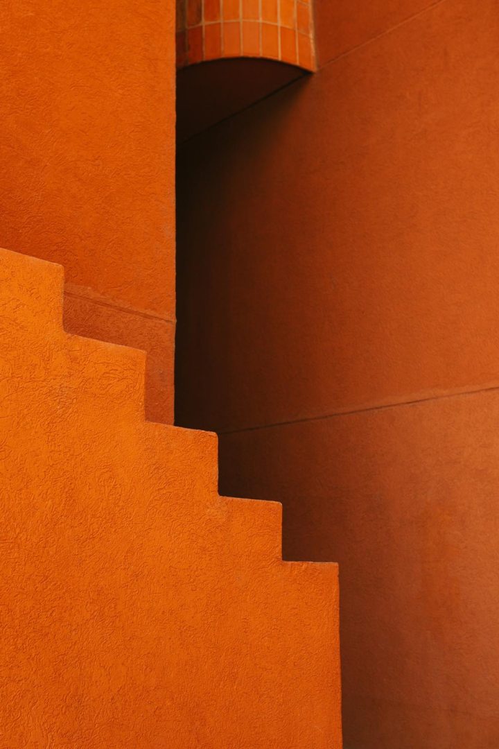 Exterior design of landmark building with orange walls and stairway located in Barcelona, Spain